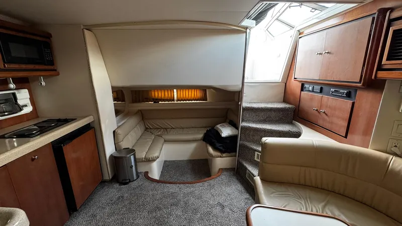 Slide: The Image of Interior of a 1999 Trojan 40 Express yacht with kitchen and seating area. - 6