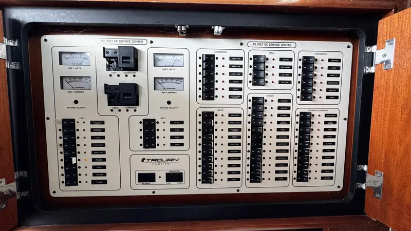 Slide: The Image of Electrical control panel of a 1999 Trojan 40 Express yacht with switches and meters. - 9