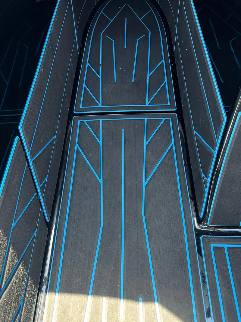Slide: The Image of 2021 Centurion Fi25 boat interior with sleek black and blue geometric design. - 5