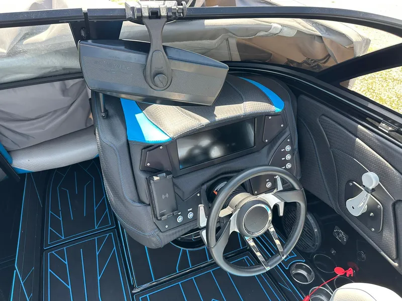 Slide: The Image of 2021 Centurion Fi25 boat dashboard with steering wheel and control panel. - 8