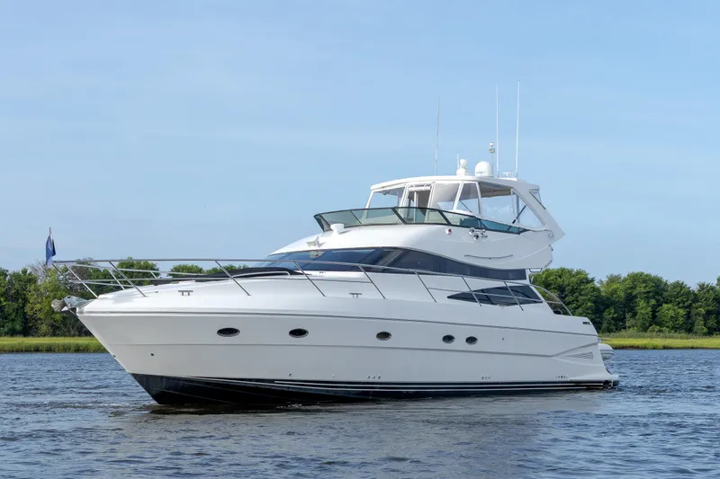 Slide: The Image of 2004 Neptunus 56 Flybridge yacht cruising on a calm river. - 0