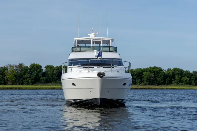 Slide: The Image of Front view of 2004 Neptunus 56 Flybridge yacht on calm water. - 1
