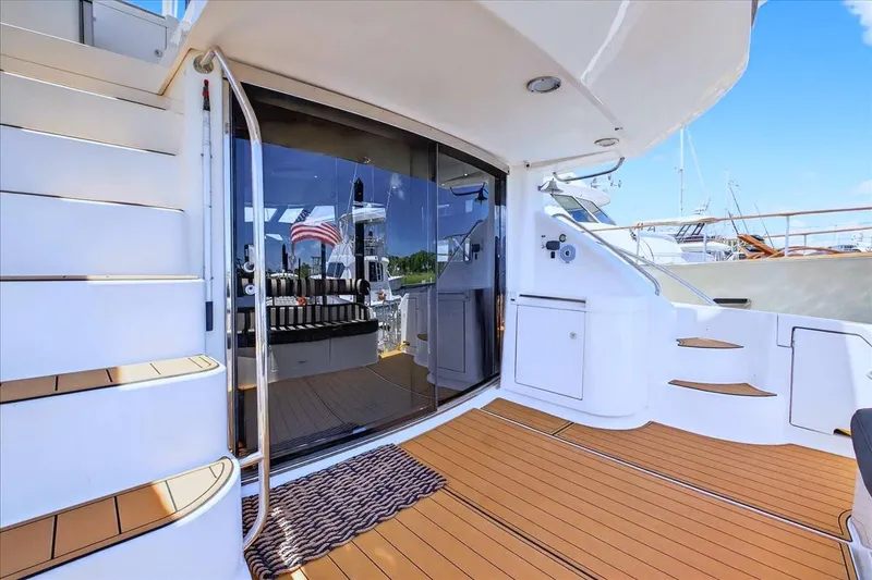 Slide: The Image of 2004 Neptunus 56 Flybridge yacht deck with stairs and glass door. - 11