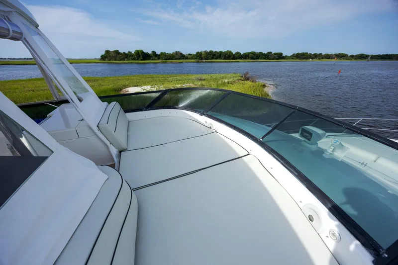 Slide: The Image of Luxurious 2004 Neptunus 56 Flybridge yacht with spacious deck overlooking serene waters. - 16