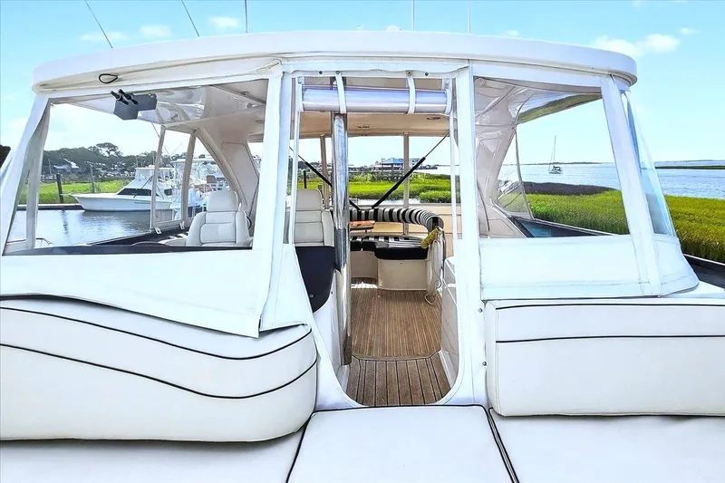 Slide: The Image of 2004 Neptunus 56 Flybridge yacht with spacious seating and scenic waterfront view. - 17