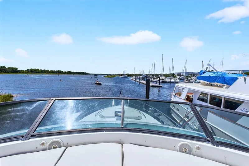 Slide: The Image of Bow view from 2004 Neptunus 56 Flybridge yacht in a marina setting. - 18