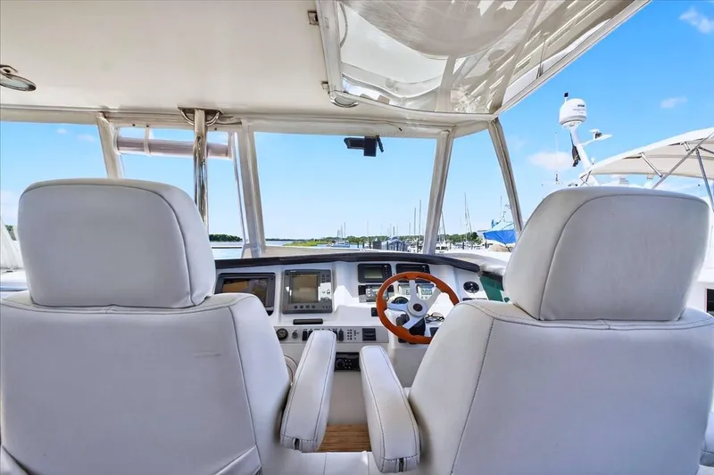 Slide: The Image of Flybridge helm of 2004 Neptunus 56 yacht with white seats and navigation equipment. - 22