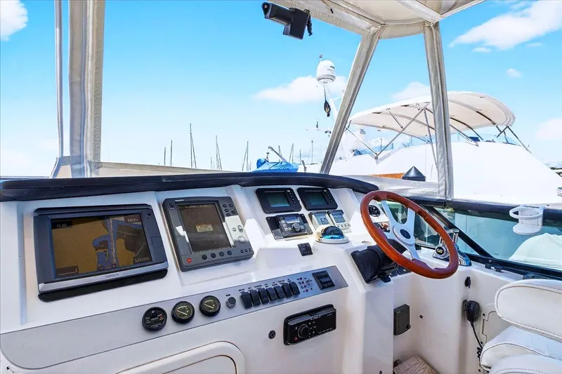 Slide: The Image of 2004 Neptunus 56 Flybridge yacht helm with navigation equipment and wooden steering wheel. - 23