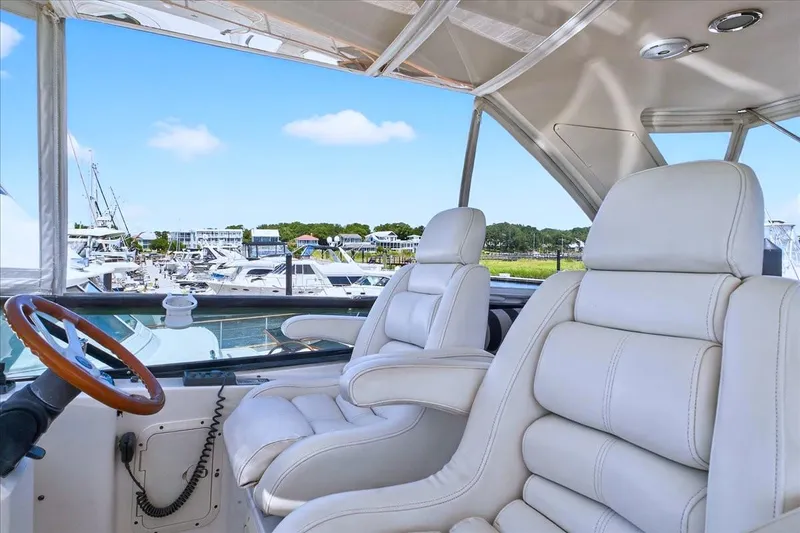 Slide: The Image of Luxurious Neptunus 56 Flybridge yacht interior with white leather seats, 2004 model. - 24