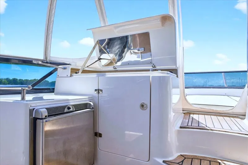 Slide: The Image of 2004 Neptunus 56 Flybridge yacht interior with sleek cabinetry and stainless steel appliances. - 25