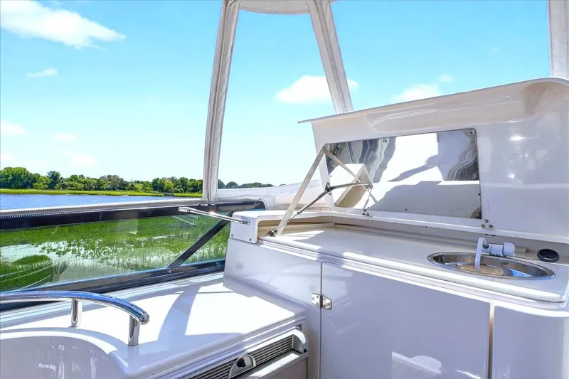 Slide: The Image of Flybridge view of 2004 Neptunus 56 yacht with sink and scenic water backdrop. - 26