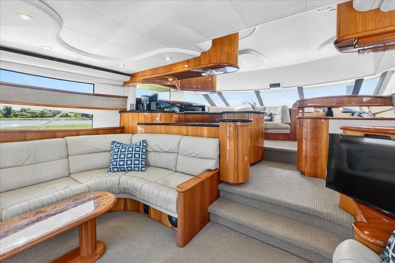 Slide: The Image of Luxurious interior of 2004 Neptunus 56 Flybridge yacht with elegant wood finishes and plush seating. - 30