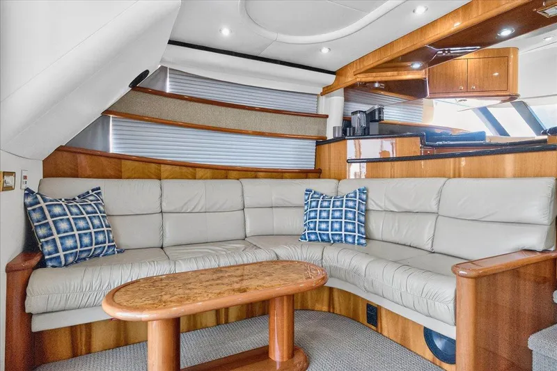 Slide: The Image of Luxurious 2004 Neptunus 56 Flybridge yacht interior with plush seating and elegant wood finishes. - 32