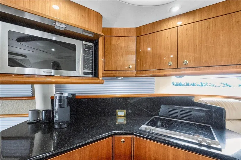 Slide: The Image of Luxurious kitchen in 2004 Neptunus 56 Flybridge yacht with modern appliances and sleek cabinetry. - 34