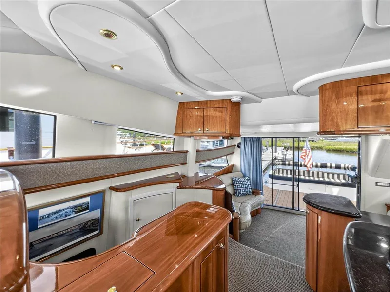 Slide: The Image of Luxurious 2004 Neptunus 56 Flybridge yacht interior with elegant wood finishes and spacious seating. - 40