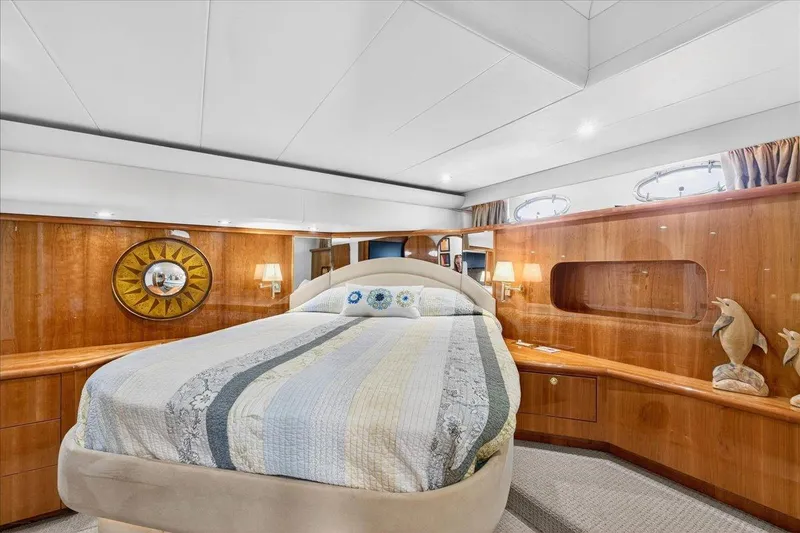 Slide: The Image of Luxurious bedroom interior of 2004 Neptunus 56 Flybridge yacht with elegant wood paneling. - 42