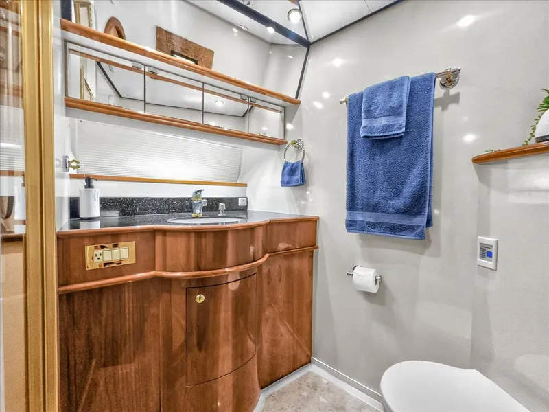 Slide: The Image of Luxurious bathroom in 2004 Neptunus 56 Flybridge yacht with wooden cabinetry and blue towels. - 46
