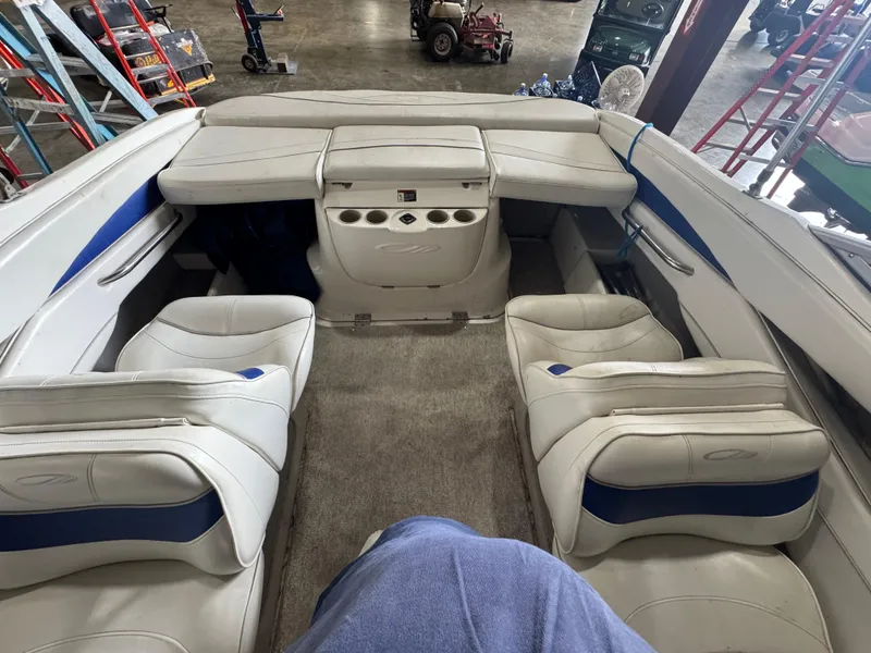 Slide: The Image of Interior of a 2004 Maxum 2100 SC boat with white and blue seating. - 2