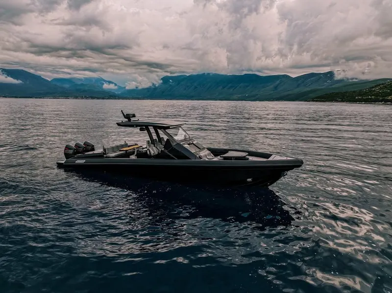 Slide: The Image of Skipper-BSK 42 boat on calm waters, 2026 model, with mountainous backdrop. - 11