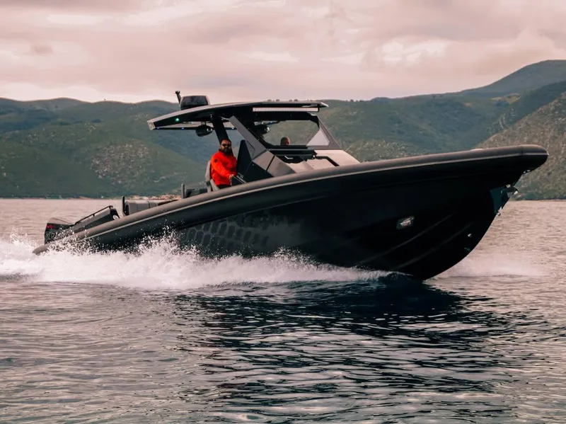 Slide: The Image of Skipper-BSK 42 boat cruising on water, 2026 model, with scenic mountain backdrop. - 2