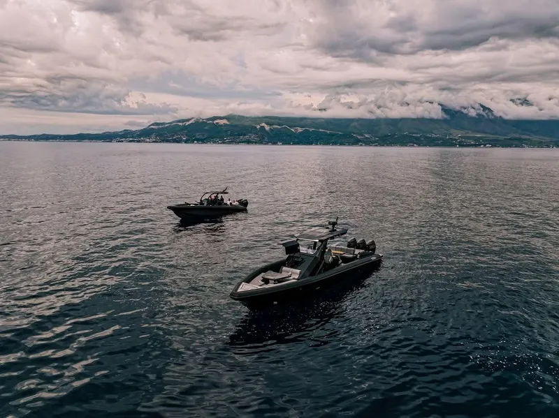 Slide: The Image of Two Skipper-BSK 42 boats on calm water under cloudy skies, 2026 model. - 5