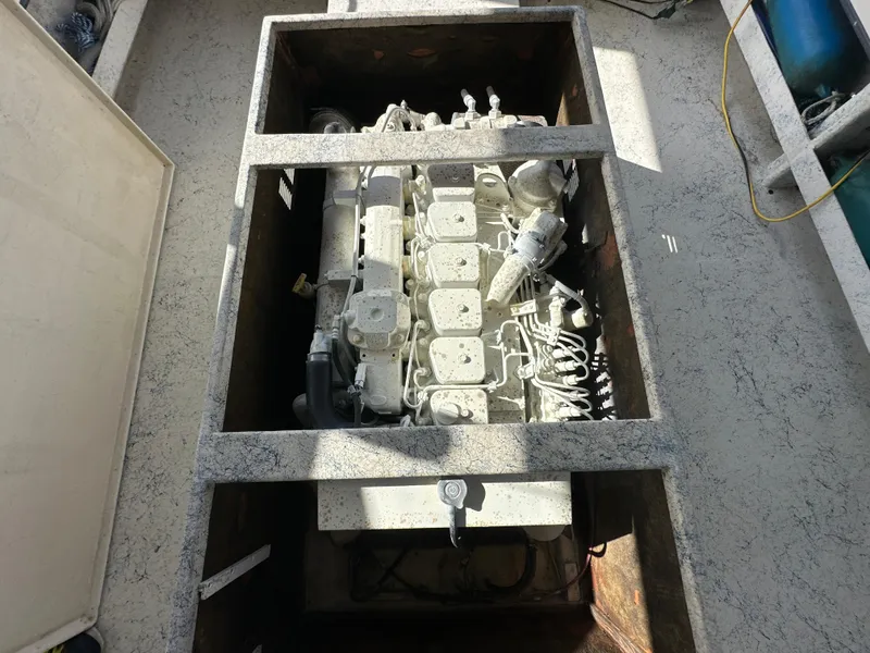 Slide: The Image of Engine compartment of 2004 Jefferson Fiberglass 32 Laffite Skiff, showcasing detailed mechanical components. - 15