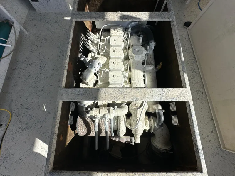 Slide: The Image of Engine compartment of a 2004 Jefferson Fiberglass 32 Laffite Skiff, showcasing detailed machinery. - 17