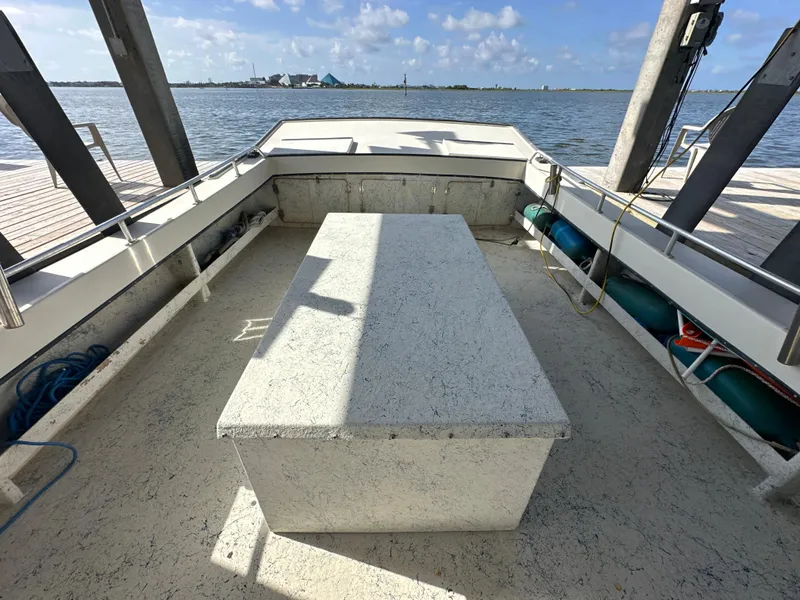 Slide: The Image of 2004 Jefferson Fiberglass 32 Laffite Skiff interior with open deck and waterfront view. - 20
