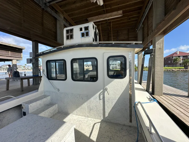 Slide: The Image of Custom 2004 Jefferson Fiberglass 32 Laffite Skiff docked under a wooden shelter. - 23