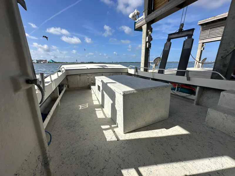 Slide: The Image of 2004 Jefferson Fiberglass 32 Laffite Skiff on water, sunny day, spacious deck. - 26