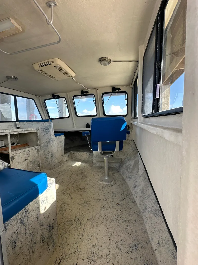 Slide: The Image of Interior of 2004 Jefferson Fiberglass 32 Laffite Skiff with blue seating and windows. - 28