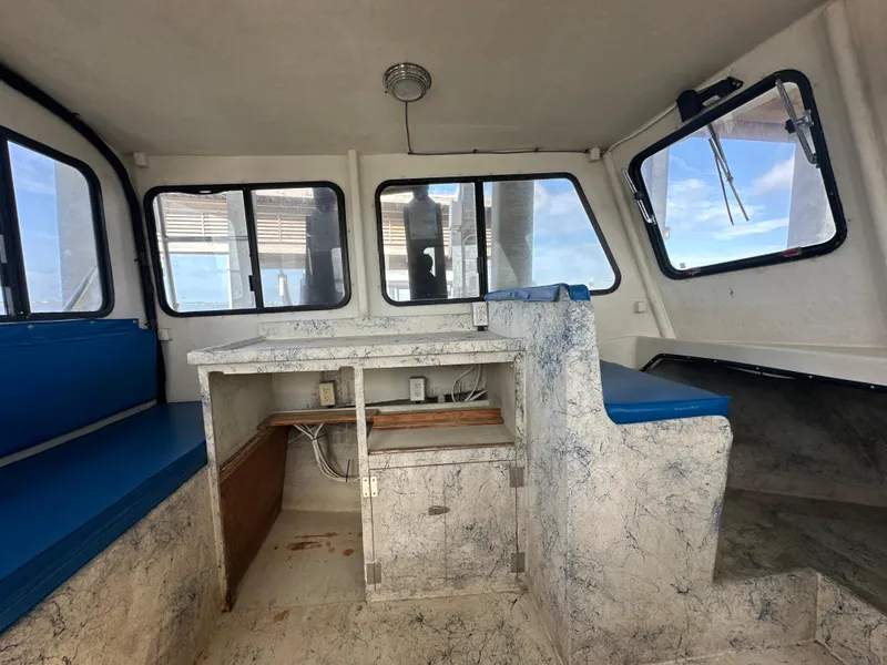 Slide: The Image of Interior of 2004 Jefferson Fiberglass 32 Laffite Skiff with blue seating and windows. - 31