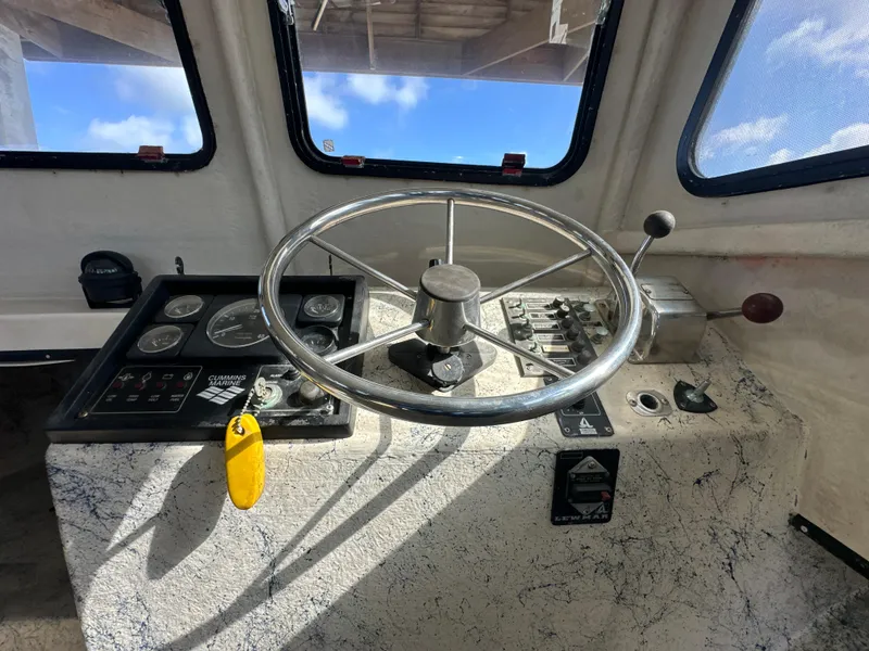 Slide: The Image of Helm of 2004 Jefferson Fiberglass 32 Laffite Skiff with steering wheel and control panel. - 36