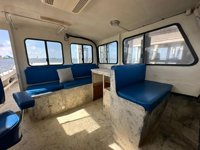 Slide: The Image of Interior of 2004 Jefferson Fiberglass 32 Laffite Skiff with blue seating and large windows. - 37