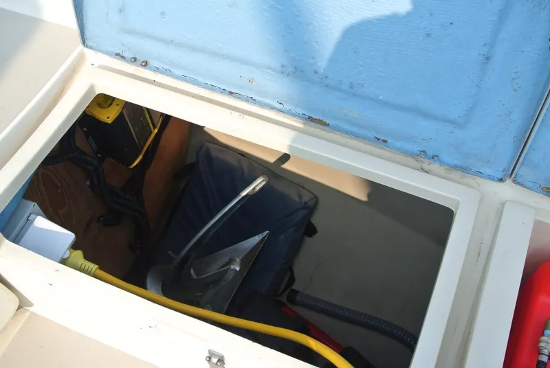 Slide: The Image of Open storage compartment on 1986 O'Day 272 sailboat, showing anchor and cables. - 18