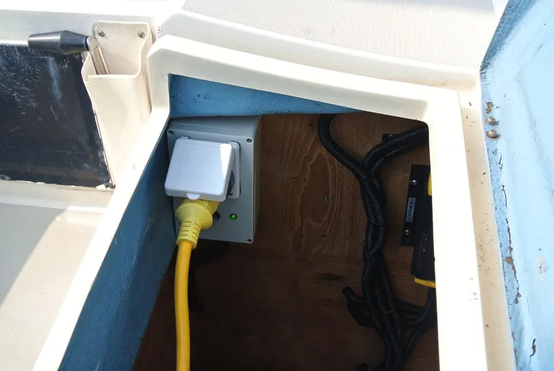 Slide: The Image of Electrical outlet with yellow cable inside 1986 O'Day 272 sailboat compartment. - 19