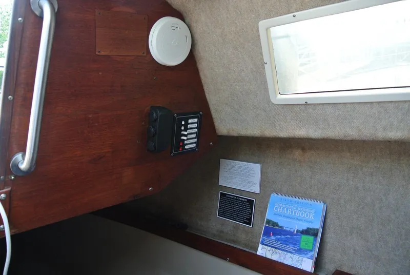 Slide: The Image of Interior of 1986 O'Day 272 sailboat with chartbook and control panel. - 23