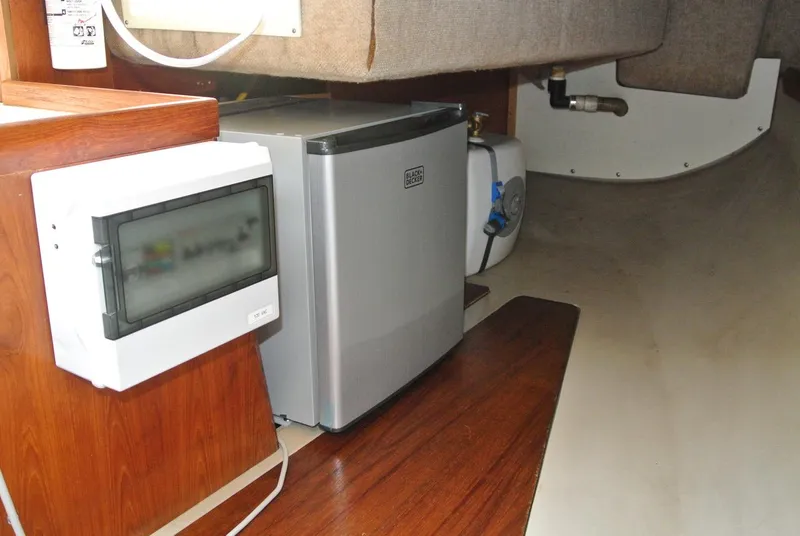 Slide: The Image of Interior of 1986 O'Day 272 sailboat with mini fridge and electrical panel. - 24