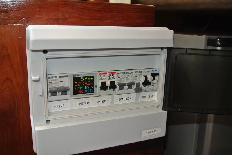 Slide: The Image of Electrical panel on a 1986 O'Day 272 sailboat, featuring various circuit breakers. - 25