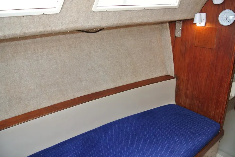 Slide: The Image of Interior cabin of 1986 O'Day 272 sailboat with blue cushioned seating. - 27