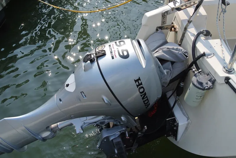 Slide: The Image of Honda outboard motor on 1986 O'Day 272 sailboat, docked in sunlight. - 3