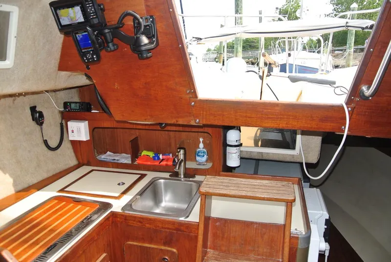 Slide: The Image of Interior of 1986 O'Day 272 sailboat with wooden cabinetry and navigation equipment. - 30
