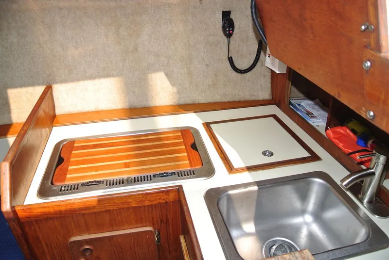 Slide: The Image of Compact galley kitchen in 1986 O'Day 272 sailboat with sink and wooden countertop. - 34