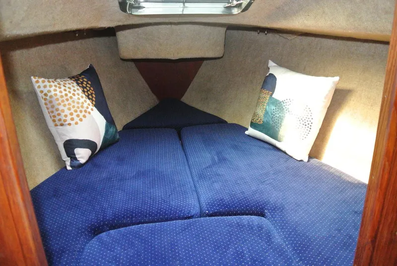 Slide: The Image of Cozy cabin interior of 1986 O'Day 272 sailboat with blue cushions and decorative pillows. - 36