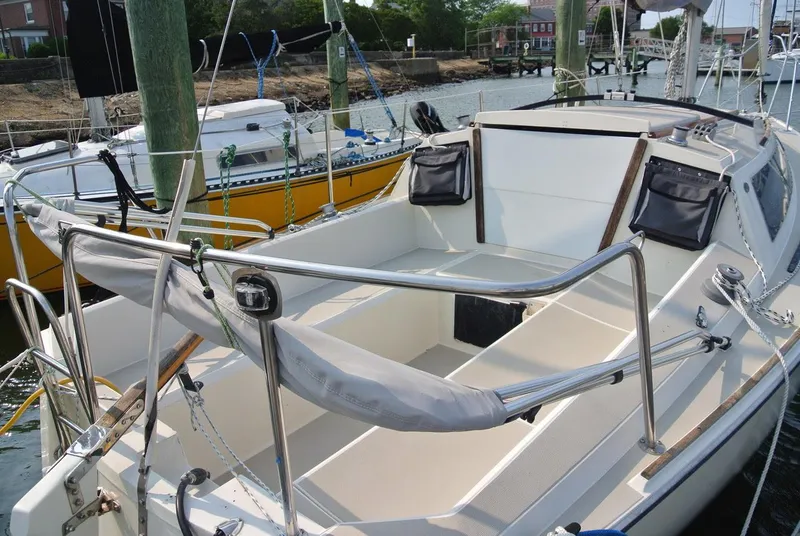 Slide: The Image of 1986 O'Day 272 sailboat cockpit with railing and storage, docked at marina. - 39