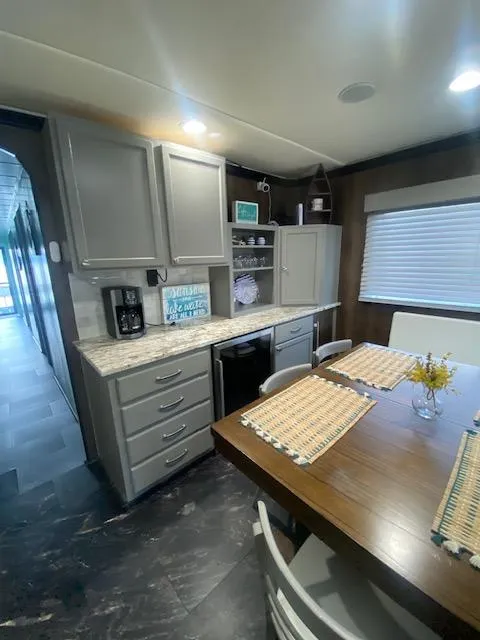 Slide: The Image of Interior of a 1992 Jamestowner 16x72 houseboat kitchen with dining area and modern decor. - 11