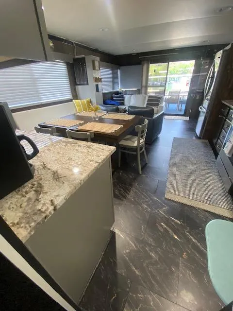 Slide: The Image of Interior of a 1992 Jamestowner 16x72 houseboat with modern kitchen and dining area. - 12