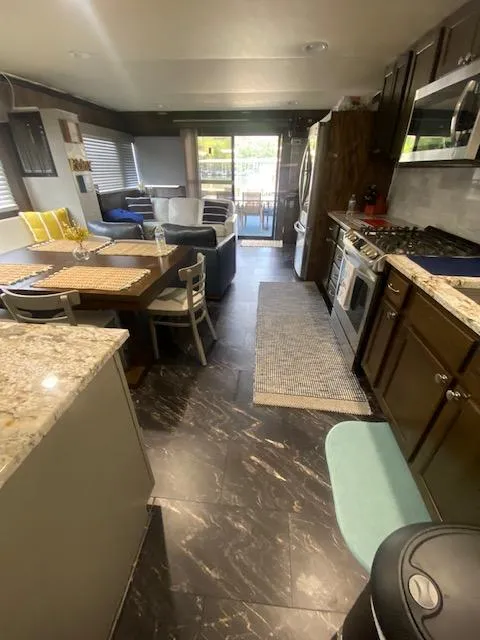 Slide: The Image of Interior of a 1992 Jamestowner 16x72 houseboat with modern kitchen and dining area. - 13