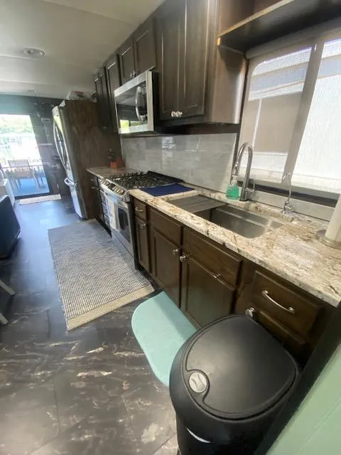 Slide: The Image of Interior of a 1992 Jamestowner 16x72 houseboat kitchen with modern appliances and granite countertops. - 14