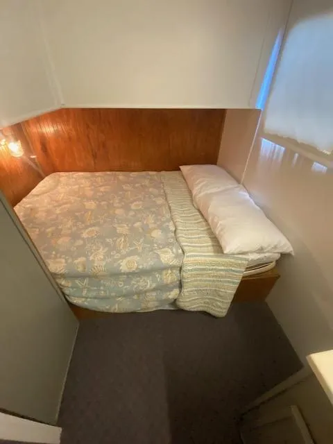 Slide: The Image of Cozy bedroom in 1992 Jamestowner 16x72 houseboat with floral bedding and wood paneling. - 15